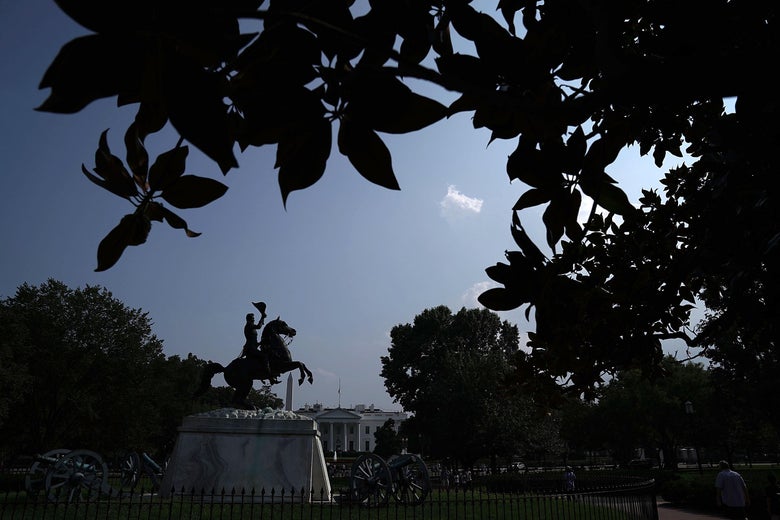 Seen behind a statue of Andrew Jackson, the American flag at the White House flies at half-staff on Monday afternoon.